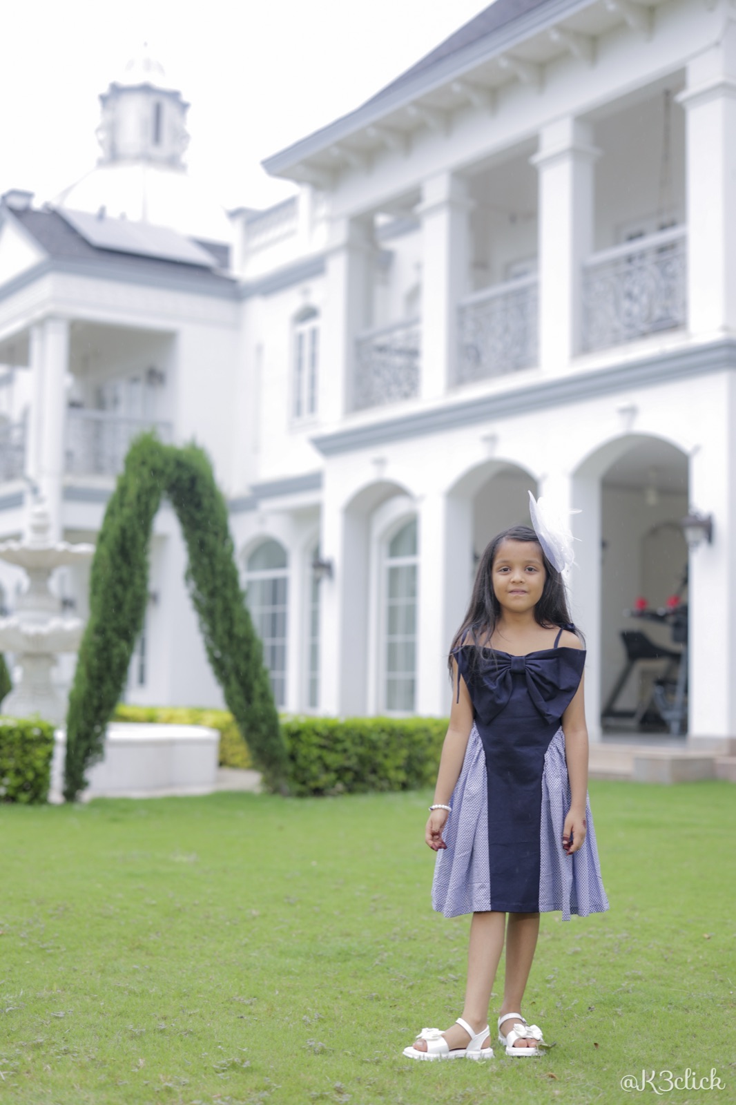 Navy bow-front dress with dotted skirt
